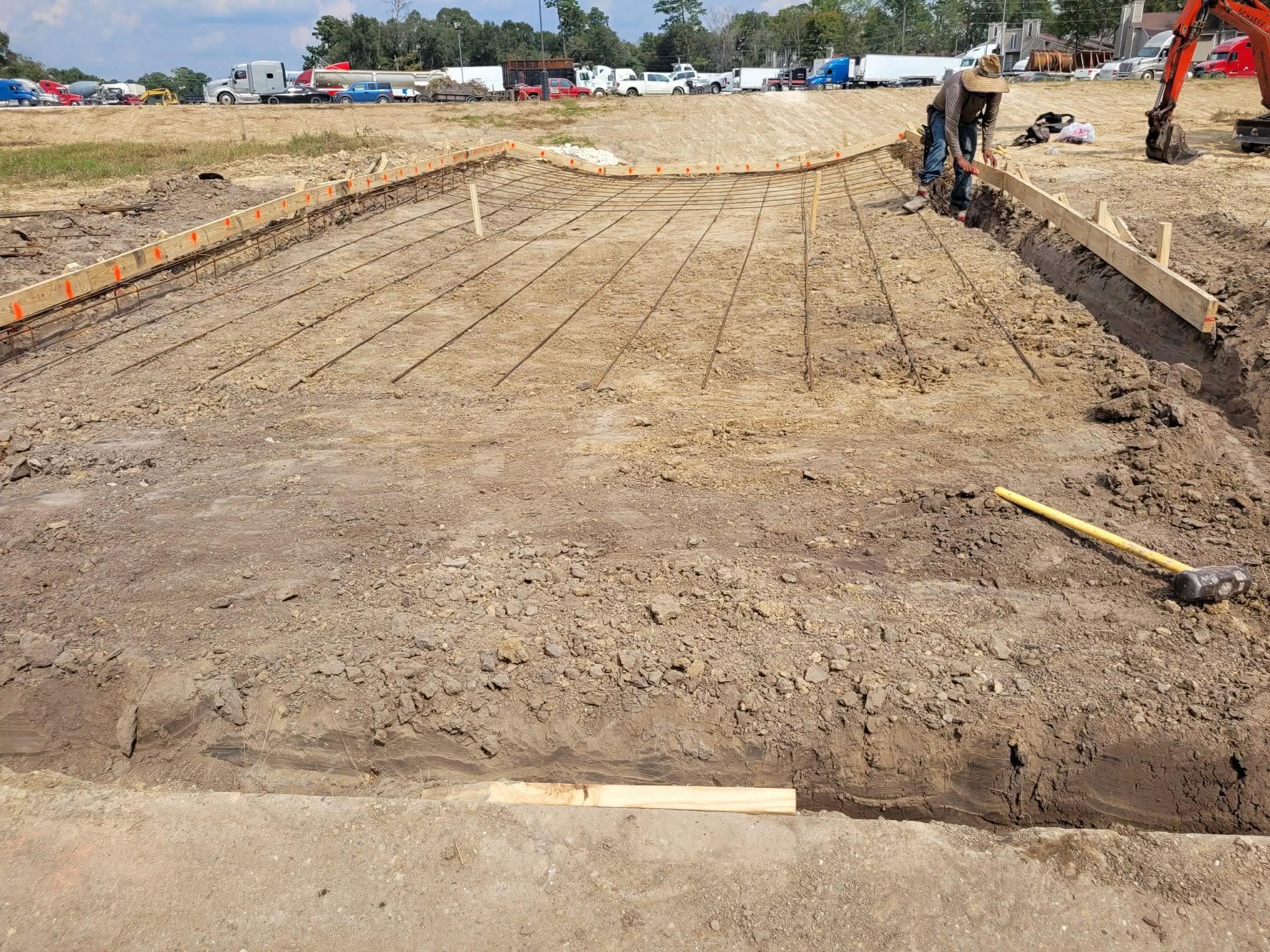 Dirt work project with graded site and excavator
