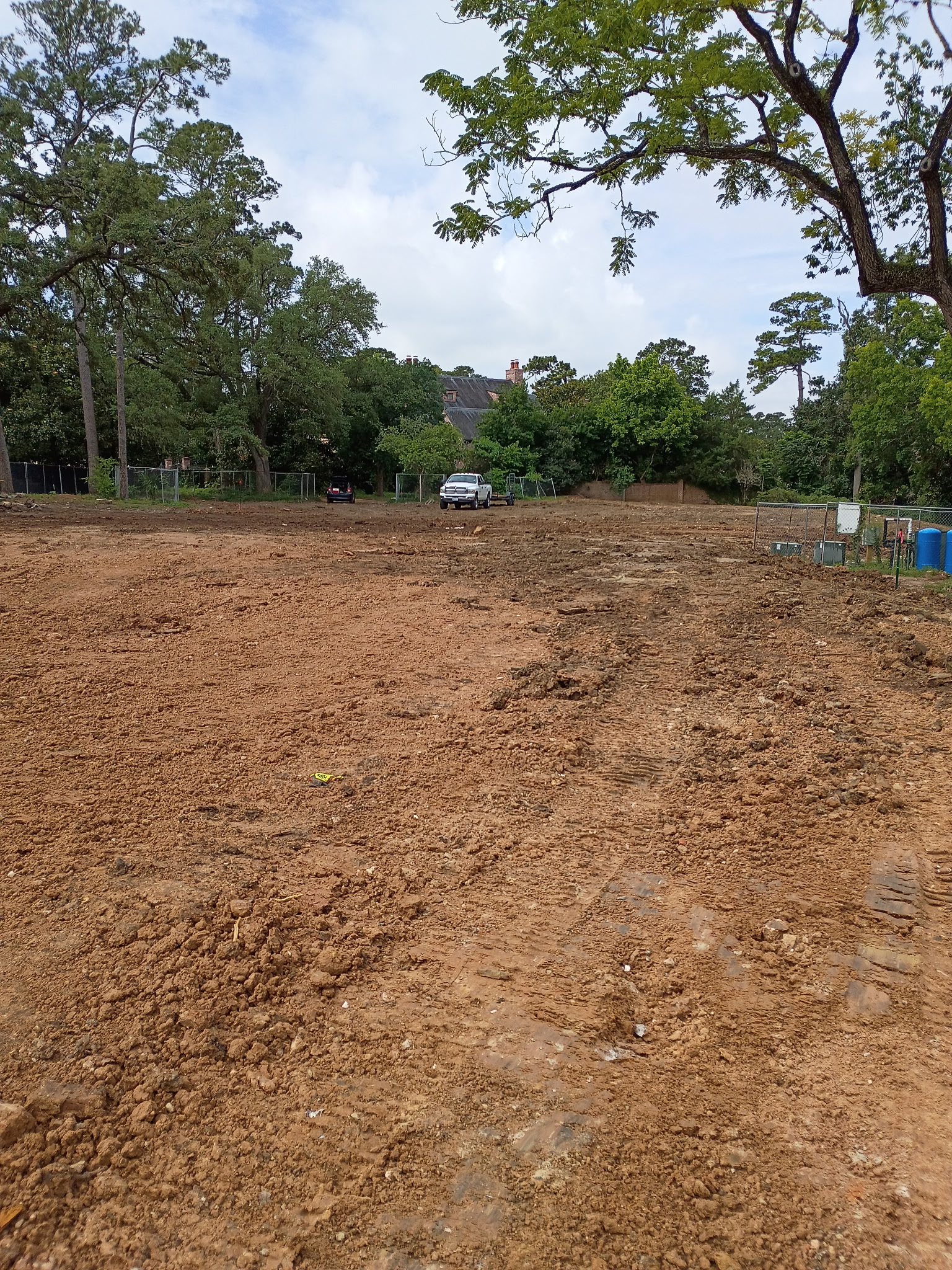 Land clearing equipment removing brush from a project site